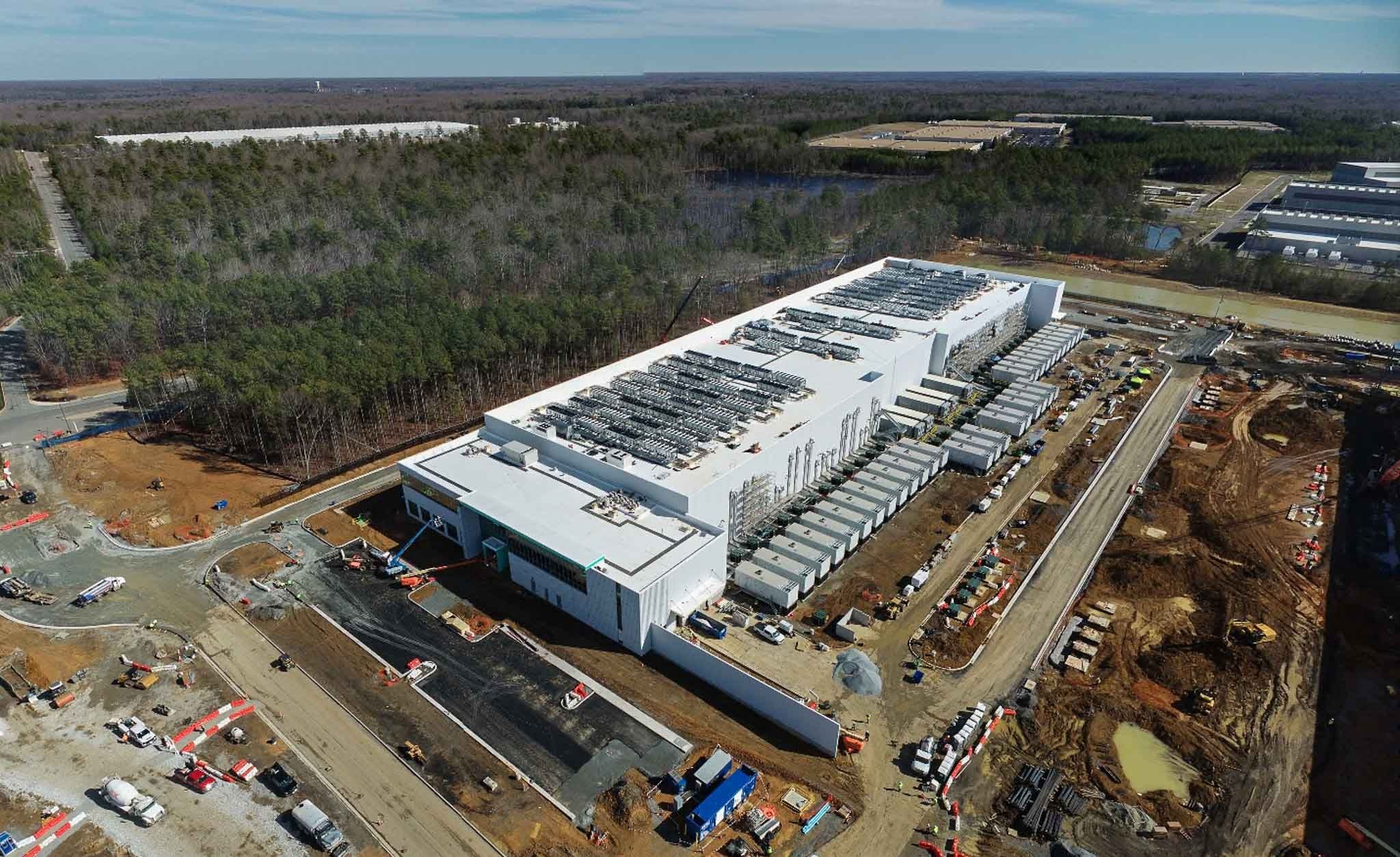 Aerial view of large construction project with cranes and extensive staging
